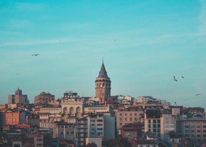 Beautiful cityscape featuring the iconic Galata Tower under a blue sky in Istanbul.