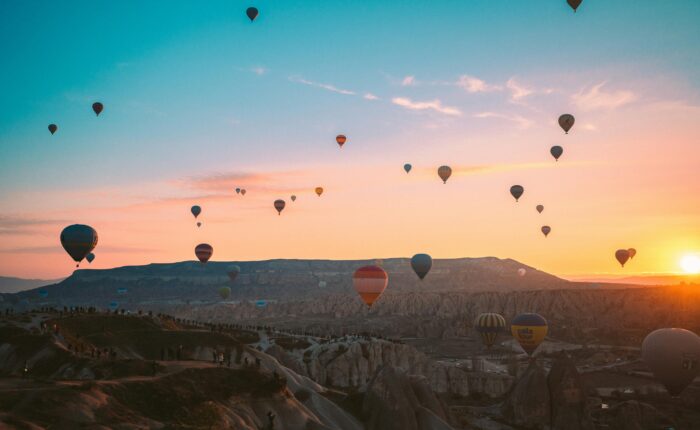 Colorful hot air balloons soaring over Cappadocia at sunrise, Turkey.